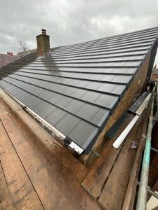 New tiled slate roof on a house